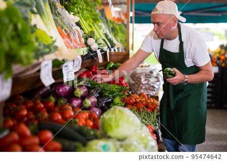 Man working in grocery store Man working in grocery store 95474642