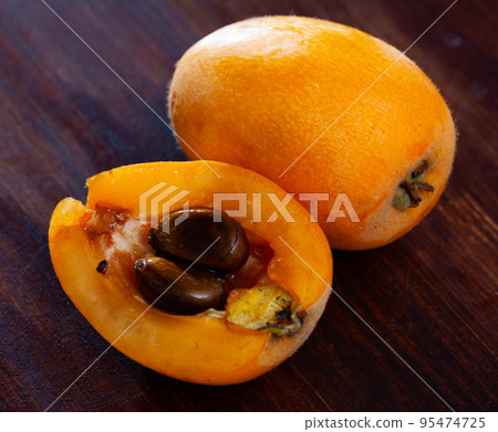 Ripe medlar fruits nispero on wooden surface 95474725