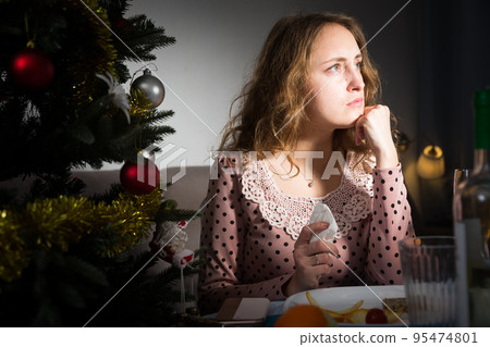Sad woman celebrating New Year Sad woman celebrating New Year 95474801