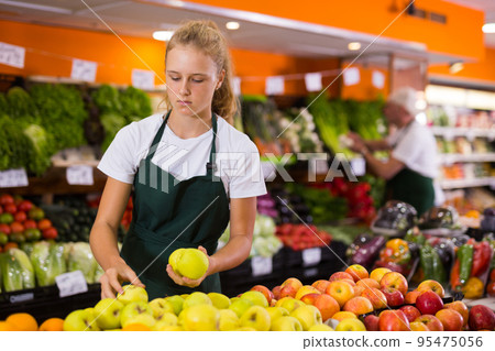 Salesgirl at her first job in vegetable shop 95475056