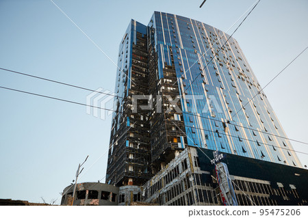 Kyiv, Ukraine - October 16, 2022: A business center building was hit by Russian shelling in Kyiv, Ukraine. After several months of relative calm, multiple explosions rocked Kyiv early Monday morning Kyiv, Ukraine - October 16, 2022: A business center building was hit by Russian shelling in Kyiv, Ukraine. After several months of relative calm, multiple explosions rocked Kyiv early Monday morning 95475206