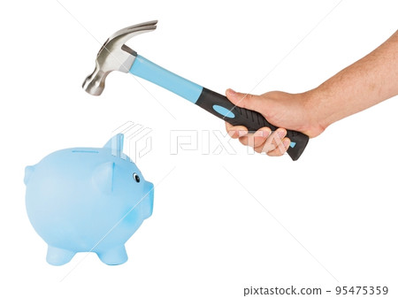 Man holding a hammer and breaking a piggy bank Man holding a hammer and breaking a piggy bank 95475359