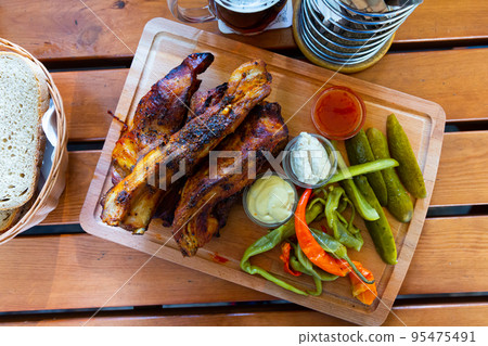 Baked pork ribs with pickles cucumbers and pepper. Baked pork ribs with pickles cucumbers and pepper. 95475491