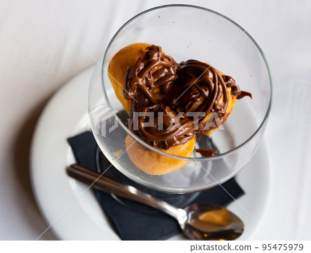 Cream profiteroles with hot chocolate 95475979