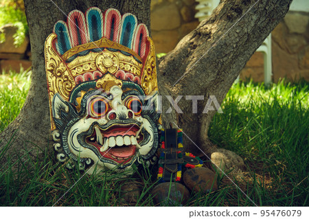 ritual Indonesian mask near a tree 95476079