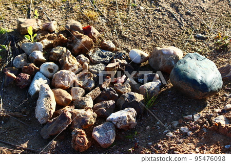 Different stones collected in a sand pit for amateur collection and processing, rockhounding Different stones collected in a sand pit for amateur collection and processing, rockhounding 95476098