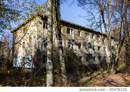 Abandoned three-story brick house with broken windows after resettlement Abandoned three-story brick house with broken windows after resettlement 95476138