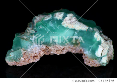 Chrysoprase on a black background - a sample of green raw collection stone, a variety of quartz and chalcedony. Field Kazakhstan Chrysoprase on a black background - a sample of green raw collection stone, a variety of quartz and chalcedony. Field Kazakhstan 95476176