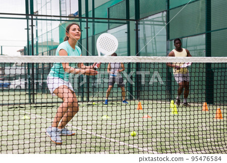 Portrait of young woman during padel training 95476584
