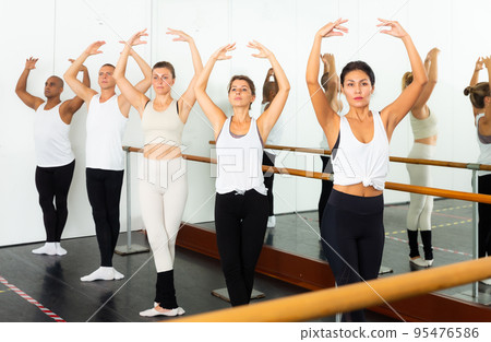 Ballet troupe performing dance in gum near mirrors Ballet troupe performing dance in gum near mirrors 95476586