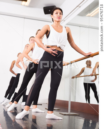 Closeup of group of women and men with their hands up during ballet class at school Closeup of group of women and men with their hands up during ballet class at school 95476718