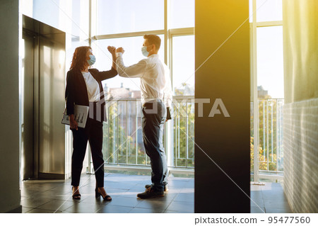 Elbow greeting to avoid the spread of coronavirus. COVID-19. 95477560