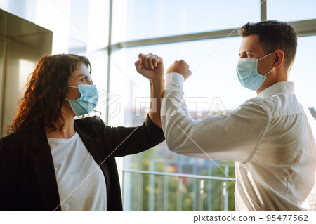 Elbow greeting to avoid the spread of coronavirus. COVID-19. 95477562