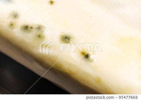 part of a pack of spoiled butter with mold. the storage of dairy products. part of a pack of spoiled butter with mold. the storage of dairy products. 95477668