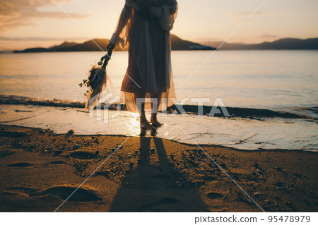 Photo of a woman standing by the beach 95478979