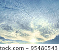 Cirrocumulus clouds lit by the autumn sun 95480543