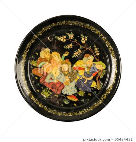 A top view of an oriental ceramic plate depicting couples painted in the center on a white background, Uzbekistan 95484451