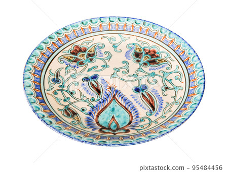 A vintage oriental ceramic plate isolated on a white background A vintage oriental ceramic plate isolated on a white background 95484456