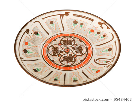 A vintage oriental ceramic plate isolated on a white background A vintage oriental ceramic plate isolated on a white background 95484462