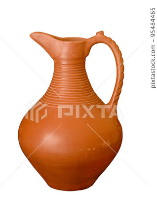 A brown clay jug isolated on a black background 95484465