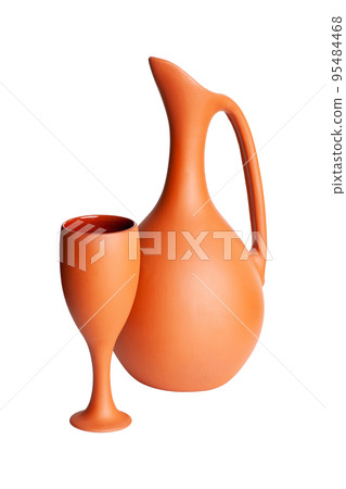 A brown clay jug with a cup isolated on a white background A brown clay jug with a cup isolated on a white background 95484468