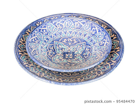 A vintage oriental ceramic plate isolated on a white background 95484470
