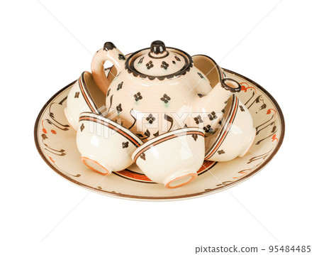 A vintage oriental ceramic teapot and cups isolated on a white background A vintage oriental ceramic teapot and cups isolated on a white background 95484485