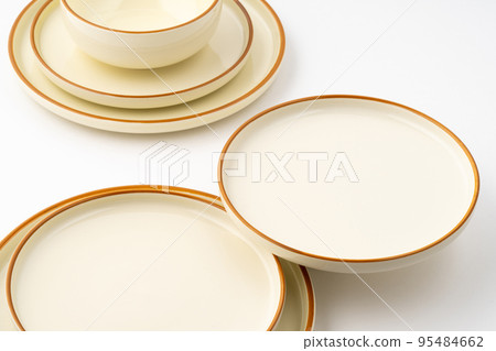 A set of white and brown ceramic plate and bowl on a white background 95484662