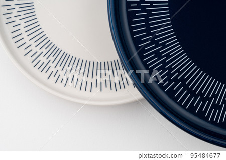 A closeup shot of a blue and white mug on a saucer with a white background A closeup shot of a blue and white mug on a saucer with a white background 95484677