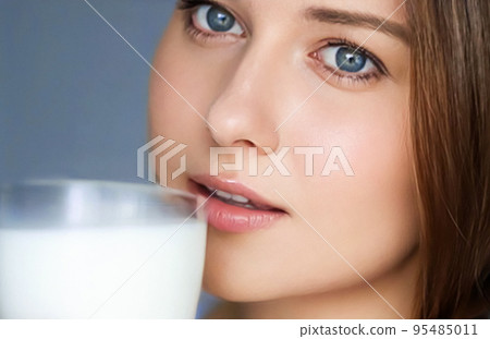 Happy young woman with glass of milk or protein milk shake, healthy cocktail drink for diet and wellness concept 95485011