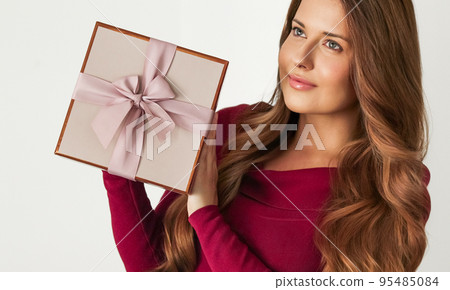 Holiday present for birthday, baby shower, wedding or luxury beauty box subscription delivery, happy woman holding a wrapped pink gift on white background Holiday present for birthday, baby shower, wedding or luxury beauty box subscription delivery, happy woman holding a wrapped pink gift on white background 95485084