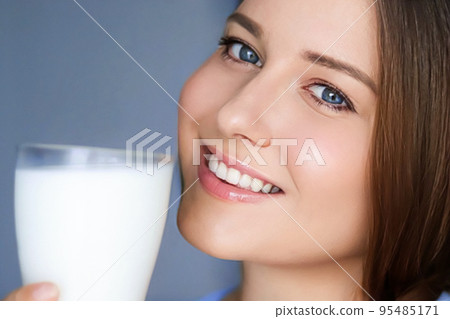 Happy young woman with glass of milk or protein milk shake, healthy cocktail drink for diet and wellness concept Happy young woman with glass of milk or protein milk shake, healthy cocktail drink for diet and wellness concept 95485171