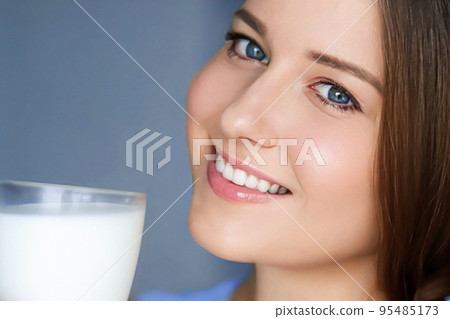 Happy young woman with glass of milk or protein milk shake, healthy cocktail drink for diet and wellness concept Happy young woman with glass of milk or protein milk shake, healthy cocktail drink for diet and wellness concept 95485173
