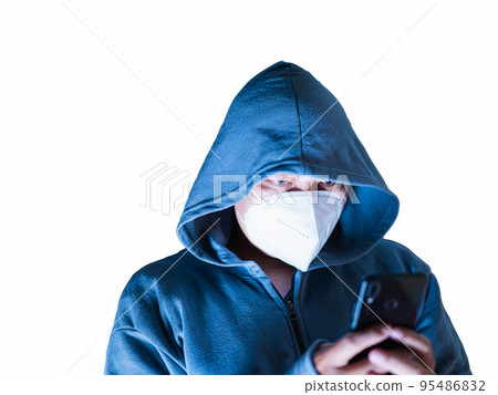 Asian man in hoodie and mask hacking Something from mobile phone in white background with clipping path Asian man in hoodie and mask hacking Something from mobile phone in white background with clipping path 95486832