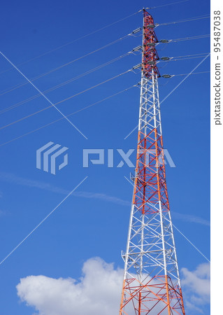 A red and white steel tower soaring in the blue sky 1 95487038