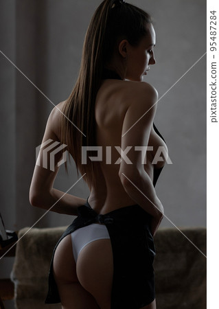 Sexy woman in apron and panties in room Sexy woman in apron and panties in room 95487284