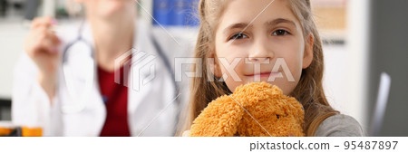 Cute smiling child at pediatrician, kid hug teddy bear favourite toy Cute smiling child at pediatrician, kid hug teddy bear favourite toy 95487897