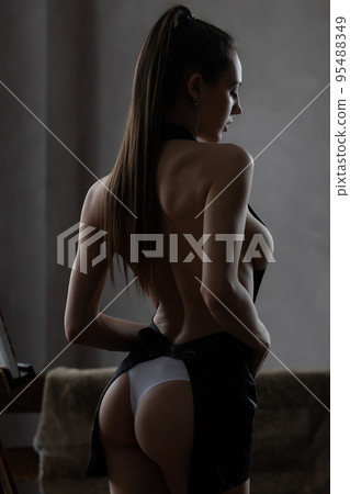 Sexy woman in apron and panties in room Sexy woman in apron and panties in room 95488349