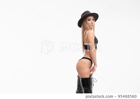 Alluring young woman in black underwear and boots 95488560