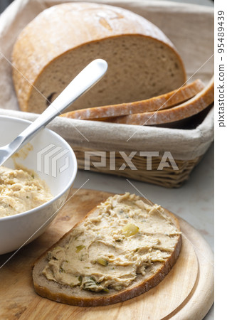 cracklings spread with pickled cucumber on slice of bread 95489439