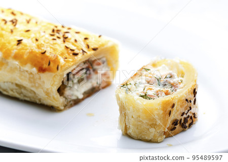 puff pastry filled with salmon, dill and cream cheese 95489597