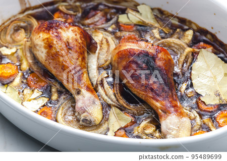 chicken legs baked with onion, carrot and bay leaves chicken legs baked with onion, carrot and bay leaves 95489699