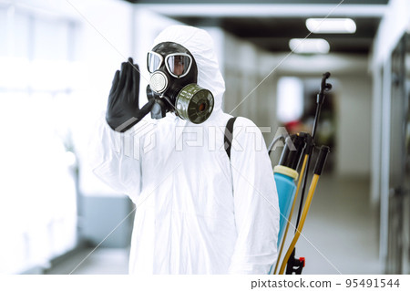 Hand stop sign. Man in protective hazmat suit shows stop hands gesture for stop coronavirus outbreak 95491544
