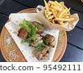 Street fast food, French fries, pita bread and pieces of grilled meat. Studio Photo 95492111