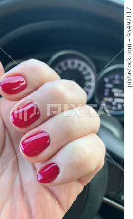 Short nails with colored nail polish on woman's hand. Stuio Photo Short nails with colored nail polish on woman's hand. Stuio Photo 95492117