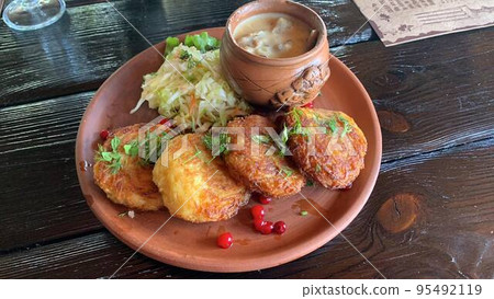 Potato pancakes with sauce, sauerkraut. Studio Photo Potato pancakes with sauce, sauerkraut. Studio Photo 95492119