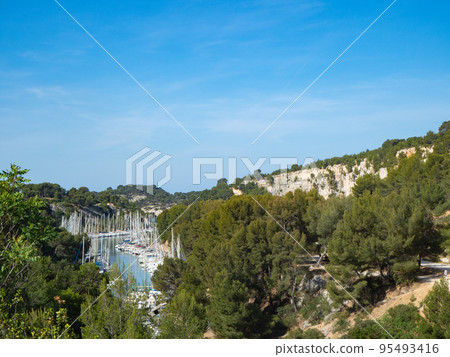 Cassis, France - May 15th 2022: Sailboats in the beautiful bay Port de Miou Cassis, France - May 15th 2022: Sailboats in the beautiful bay Port de Miou 95493416