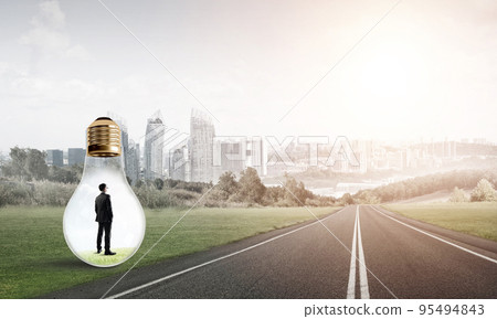 Businessman inside light bulb 95494843