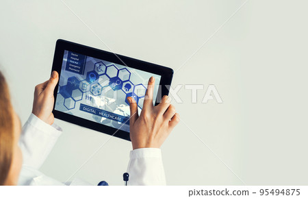 Close of female doctor hands working with tablet pc computer Close of female doctor hands working with tablet pc computer 95494875