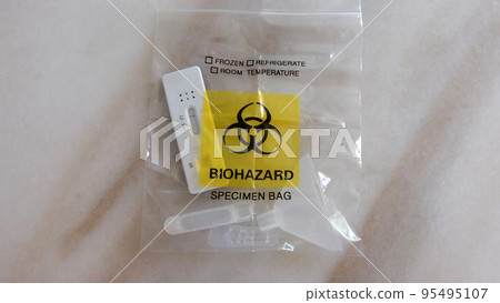 A used home test kit sealed inside the biohazard specimen bag ready to be disposed. A used home test kit sealed inside the biohazard specimen bag ready to be disposed. 95495107